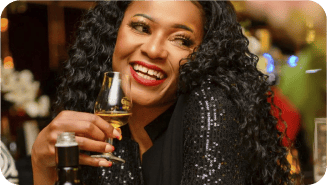 Lady laughing with drink in hand